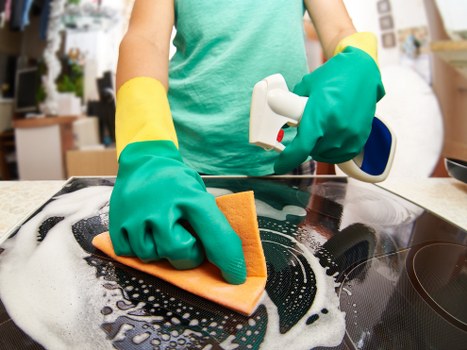 Cleaner working carefully in a Bermondsey home with attention to detail